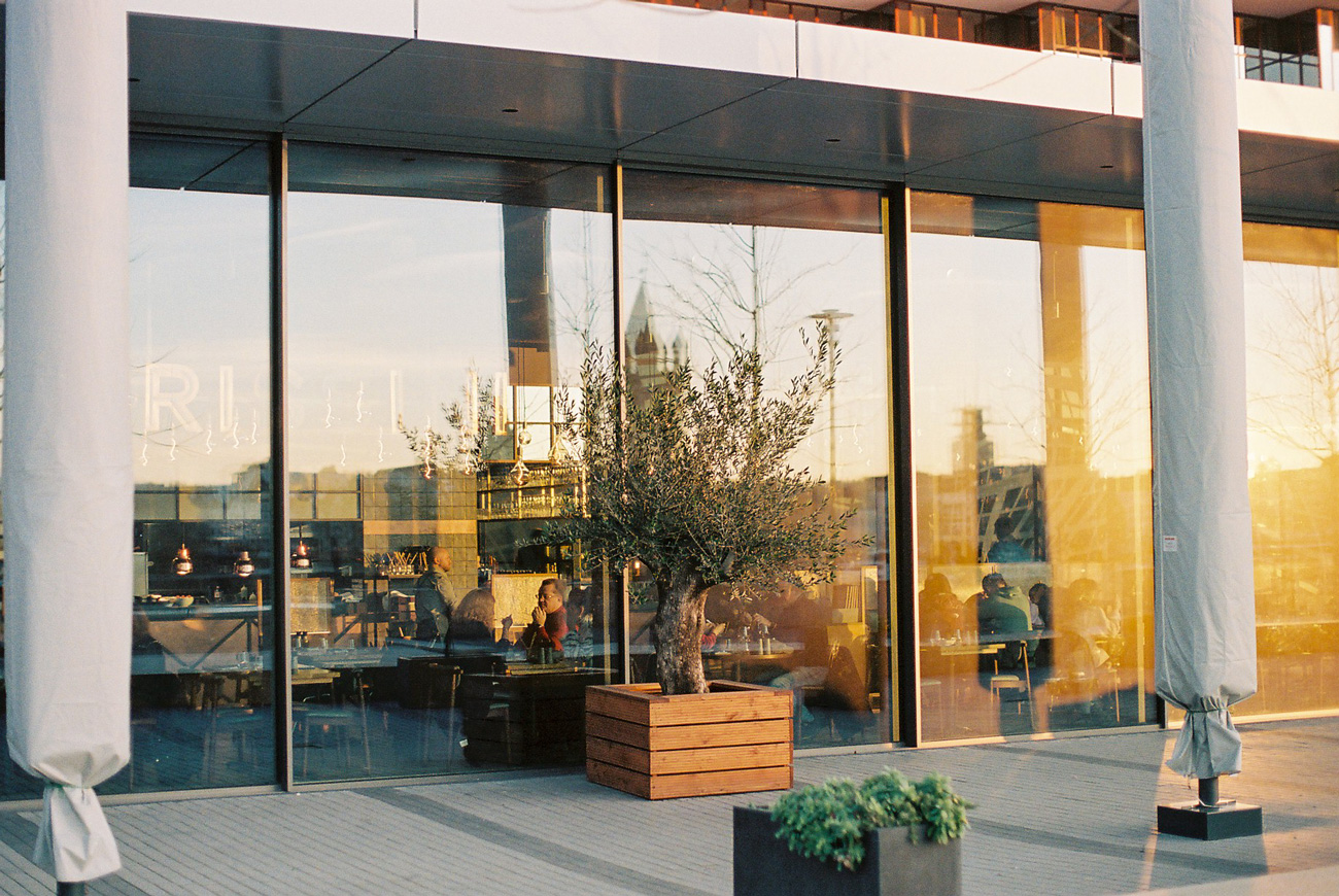 Hombre de espalda, y su reflejo en una ventana.